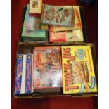 Two boxes containing a collection of various vintage puzzles to include Companion Series Landing the