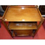 An early 20th century beechwood two-tier tea trolley, with cupboard base