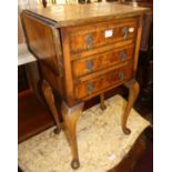 An early 20th century figured walnut and crossbanded dropflap three drawer bedside table, raised