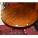 An early 19th century mahogany circular tilt-top pedestal tripod table, dia.81.5cm