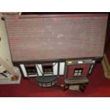 A Tudor style two storey dolls house, with removable front panel, w.70cm