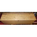 A rustic pine hinge topped blanket box, having end carry handles and on flattened bun supports, w.
