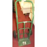 A green painted metal sack barrow with articulated wheels