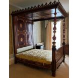 An unusual late 19th century Continental mahogany and satinwood inlaid double full tester bed, the
