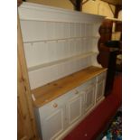 A contemporary pine and part white painted kitchen dresser, the two-tier open plate rack over base