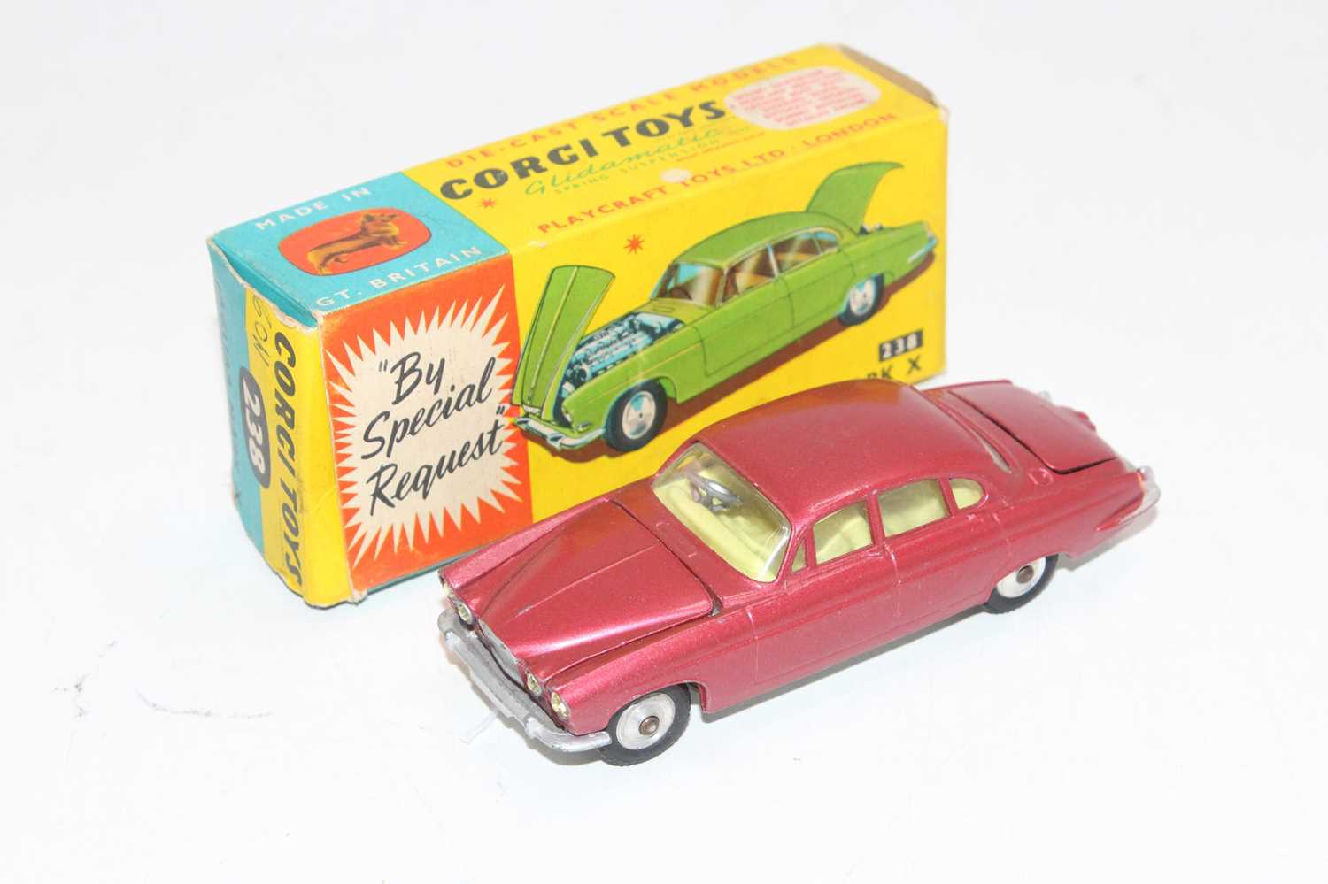 A Corgi Toys No. 238 Jaguar Mk X, comprising of metallic cerise body with lemon interior, housed