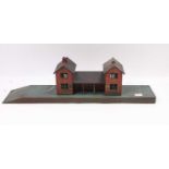 Bing Gauge 0 station with two buildings joined by a covered way. Each building has the fitment for