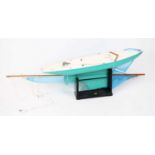 A scratch built wooden model of a Pond Yacht, comprising green and white hull with a weighted