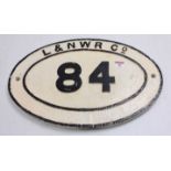L&NWR Co. bridge plate no.84, white with black letters, mounted on wooden backing board