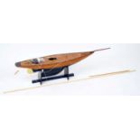 A wooden kit built model of a sailing boat, comprising of wooden planked hull with a weighted