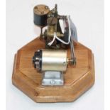 An electrically powered miniature single oscillating vertical steam engine, fitted with displacement