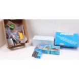 2 boxes containing a collection of Playmobil boxed track, spares, batteries and boxed accessory
