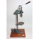 A hand-operated belt-driven pillar drill, raised on wooden display plinth, vendor states scratch