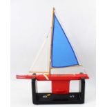 A HB Models wooden sailing yacht, comprising of red-painted hull with a weighted keel, fitted with 2