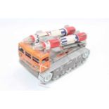 Daiya Japan tinplate battery operated missile launcher vehicle in orange and silver with two rockets