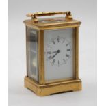 A French lacquered brass cased carriage clock having an enamel dial with inner Roman numerals and