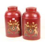 A pair of reproduction red toleware type armorial tea canisters, h.43cm