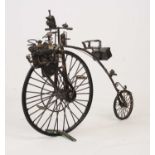 A 20th century sculpture of a motorised Penny Farthing, constructed from scrap metal, h.32cm