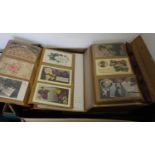 An album of 19th century and later postcards and greetings cards; together with an album of Royal