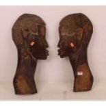 A pair of 20th century African hardwood carvings, in the form of the profile of a man and woman,