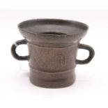 An antique bronze mortar, of circular form, flanked by twin loop handles, height 12cmCondition