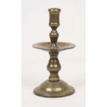 A 19th century bronze candlestick, standing upon a circular foot, h.23cm