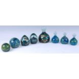 A collection of eight various Mdina glass paperweights, each in various patterns with cased and