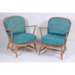 A pair of Ercol light elm stickback elbow chairs, having patterned upholstered cushion backs and