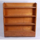 A 1950s light oak four-tier double-sided open bookshelf, of slightly tapering form, h.115cm, w.