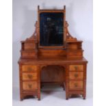 In the manner of Charles Bevan - an Arts & Crafts oak and inlaid kneehole dressing table, having