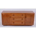 An Ercol blond elm Windsor sideboard, the three central drawers flanked by conforming cupboard