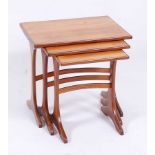 A 1960s G-Plan teak nest of three occasional tables, raised on curved and outswept supports,