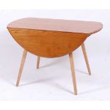 An Ercol light elm dropflap kitchen table, having oval fall leaves, raised on square tapering