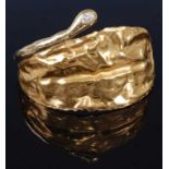 A 1970s 18 carat gold and single stone diamond set bangle, of naturalistic leaf form, with hinged