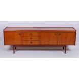 A 1960s teak long sideboard, having thumbmoulded top detail, over three drawers and three further