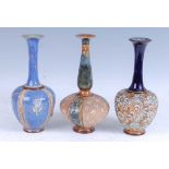 A collection of three Royal Doulton Lambeth stoneware bottle vases, each with a flared rim above a