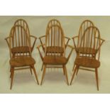 A set of four Ercol blond elm stickback elbow chairs, having dished seats, each w.62cm; together