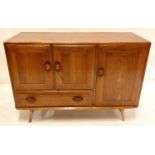 A 1960s Ercol light elm Windsor sideboard, model No.366, with arrangement of three cupboard doors