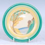 A 1930s Clarice Cliff Secrets pattern side plate, decorated with a stylised tree before the ocean in