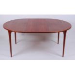 A 1960s teak D-end extending dining table, having a pull out action and two extra drop-in leaves,