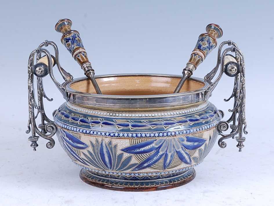 An 1879 Doulton Lambeth stoneware salad bowl, the silver plated rim flanked by a pair of silver