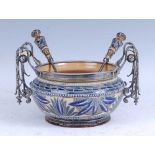 An 1879 Doulton Lambeth stoneware salad bowl, the silver plated rim flanked by a pair of silver