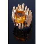 A 1970s 9 carat gold and topaz set dress ring by Albion Craft Company, the emerald cut stone