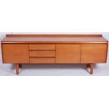 A 1960s teak long sideboard by White & Newton Ltd, having curved raised back, with three drawers