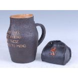 A late 19th century Doulton Lambeth stoneware jug, in the form of a leather blackjack, inscribed '