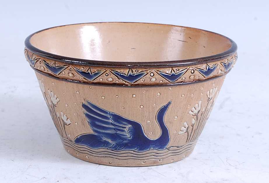 An 1878 Doulton Lambeth stoneware flower pot, decorated with swans, incised monogram for Hannah