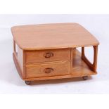 An Ercol light elm 'Pandora's Box' square coffee table, having twin short drawers and open