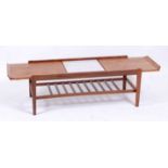 A 1960s teak low rectangular coffee table by Remploy, with extending action and central laminate