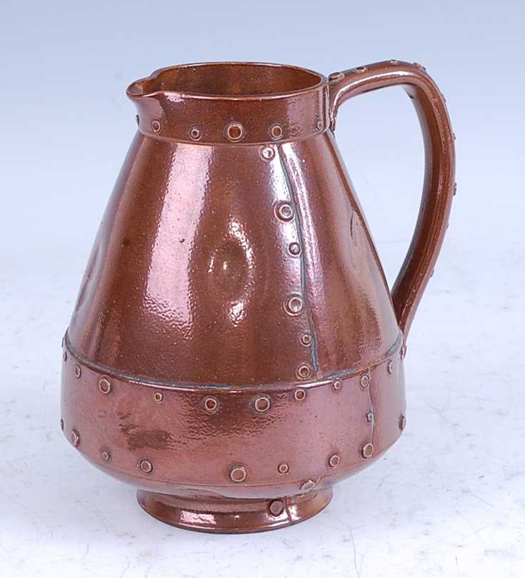 A circa 1900 Doulton Lambeth silicon-ware copper lustre jug, in the form of a riveted copper jack,