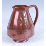 A circa 1900 Doulton Lambeth silicon-ware copper lustre jug, in the form of a riveted copper jack,